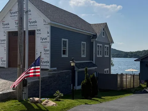 Finished navy HardiePlank lakefront home